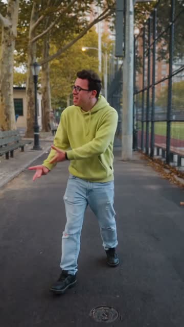 Point & stroll — Arm out, pointing past the camera, still walking the line.